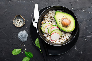 Vegetarian dish. Avocado, vegetables, rice bowl. Healthy food for all. Without meat. Top view