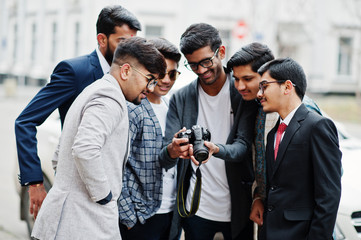 Fototapeta na wymiar Group of six south asian indian mans in traditional, casual and business wear. Asia tourists looking at the dslr photo camera.