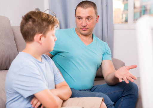 Man with his adult son are serious talking about life together