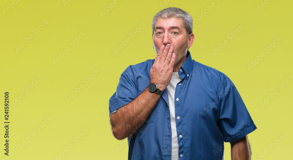 Wall mural Handsome senior man over isolated background bored yawning tired covering mouth with hand. Restless and sleepiness.