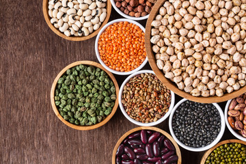 Various assortment of indian legumes - beans, chickpeas, lentils, dal top view. - obrazy, fototapety, plakaty