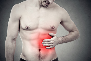 Muscular man with stomach pain