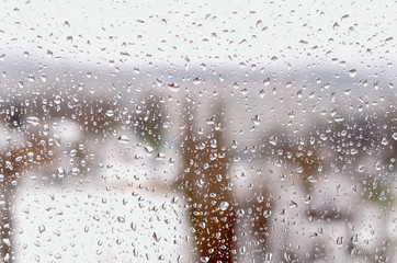 Drops of rain or sleet on the window in winter