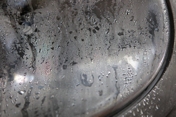 Water droplets on the brewing equipment. Condensation on the hatch. Beer production. Condensation on the smooth surface of the metal.