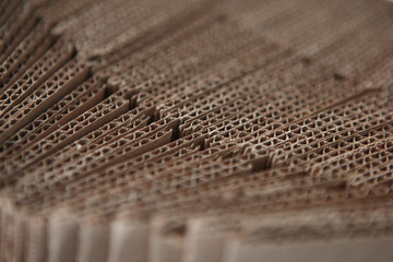 The texture of cardboard paper, side view. Cardboard paper in a stack of beige. Cardboard for packing boxes.