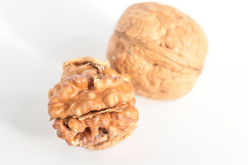 Shelled walnuts and walnut kernels. Stock Photo.