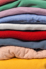 Stacks of folded clothes, close up .
