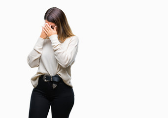 Fototapeta premium Young beautiful woman casual white sweater over isolated background with sad expression covering face with hands while crying. Depression concept.
