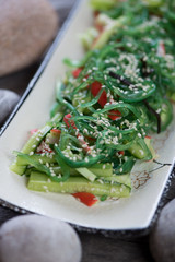 Close-up of salad with seaweed, crab meat and cucumber, selective focus, vertical shot