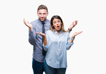 Young workers business couple over isolated background clueless and confused expression with arms...