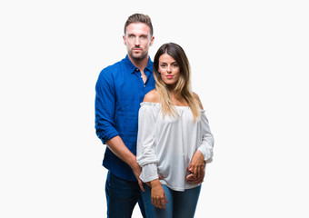 Young couple in love over isolated background with serious expression on face. Simple and natural looking at the camera.