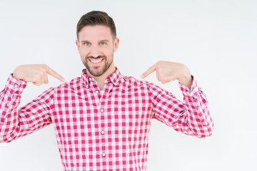 Young handsome man wearing shirt over isolated background looking confident with smile on face,...
