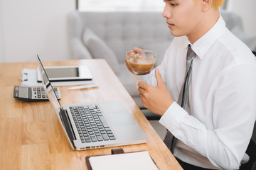Businessman holding a cup of coffee in the break. Concept of office work and a rest break.