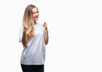 Young beautiful blonde woman wearing casual white t-shirt over isolated background pointing fingers to camera with happy and funny face. Good energy and vibes.