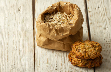 Oatmeal cookies with milk on tray on rustic wooden table