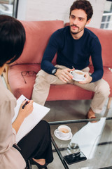 job interview. handsome beraded man having a consultation with a psychologist. close up photo....