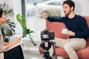 conflict between a journalist and a celebrity during online show. blurred background. close up photo