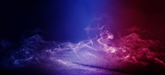 The background of wet asphalt, the reflection of the night lights of the city, neon light, smoke