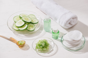Obraz na płótnie Canvas Cosmetic bottle and fresh organic cucumber for skincare. Home spa concept.