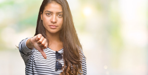 Young beautiful arab woman wearing sunglasses over isolated background looking unhappy and angry showing rejection and negative with thumbs down gesture. Bad expression.