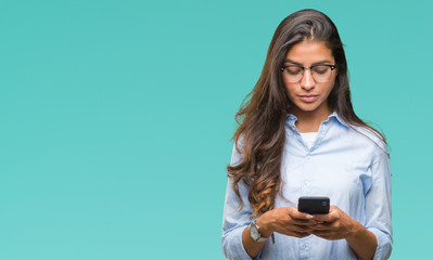 Young beautiful arab woman texting using smartphone over isolated background with a confident expression on smart face thinking serious