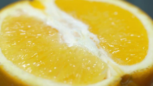 close up, half an orange 360 degree torning on a wooden background, macro shot, tasty healthy food