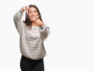 Young beautiful arab woman wearing winter sweater over isolated background smiling making frame with hands and fingers with happy face. Creativity and photography concept.