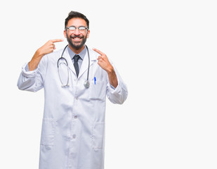 Adult hispanic doctor man over isolated background smiling confident showing and pointing with fingers teeth and mouth. Health concept.