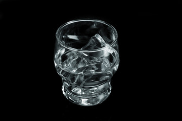 Chilled Water with Ice Cubes on Black Background