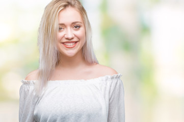 Young blonde woman over isolated background with a happy and cool smile on face. Lucky person.