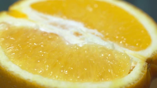 close up, half an orange 360 degree torning on a wooden background, macro shot, tasty healthy food