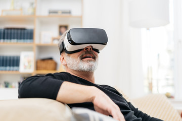 Man sitting using 3D virtual goggles