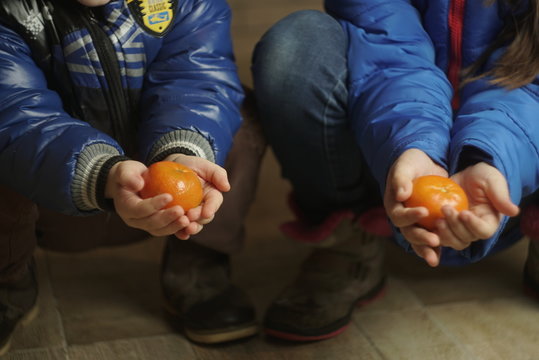 Tangerines in the hands of children