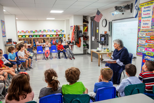 Teacher teaching a classroom full of children