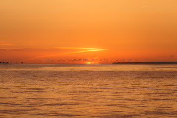 Colourful orange sunset with bright clear sky over Baltic sea.