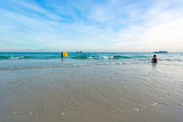 Travelers are playing in the sea and relaxing on the beach happily. During the high season at Koh Samet, the Gulf of Thailand, Rayong Province, campaigning for tourism in Thailand