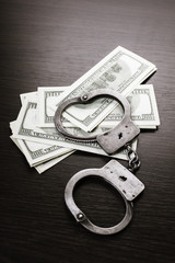 handcuffed and paper money