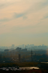 The sun shines in the summer against the background of houses in the city