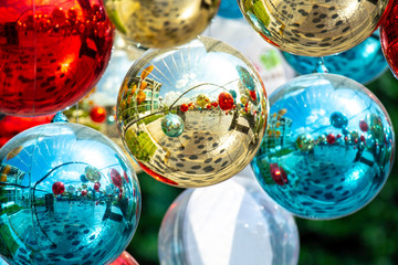 Christmas balls decoration with twinkling light and ornament on fir over colorful bokeh with festive. Shiny xmas glass baubles ball background. Merry Christmas and Happy New Year.