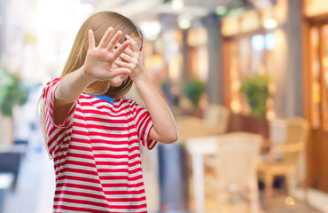 Young beautiful girl over isolated background covering eyes with hands and doing stop gesture with sad and fear expression. Embarrassed and negative concept.