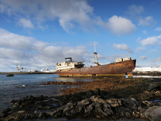 The wreck of an old cargo ship lies on the rocks of the coast of Lanzarote. A storm had made her shipwreck in the 1800s and the sea and the saltiness are destroying her.