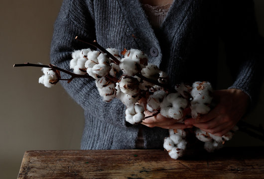 Woman with cotton twigs
