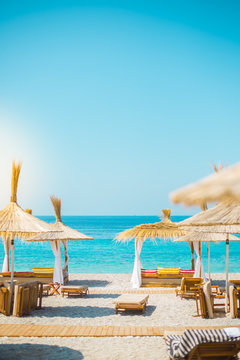 Sunshade umbrellas and deckchairs on the beautiful beach in Himara, Albania.