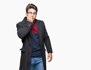 Young handsome elegant man wearing glasses over isolated background looking stressed and nervous with hands on mouth biting nails. Anxiety problem.