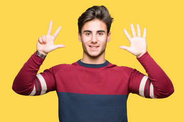 Young handsome man over isolated background showing and pointing up with fingers number eight while smiling confident and happy.