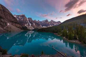 The Moraine Lake with turquoise lake and mountain reflection in sunset beautiful sky
