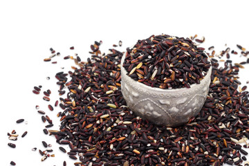 Black glutinous rice, Black sticky rice (Oryza sativa Linn.) in a cup isolate on white background.