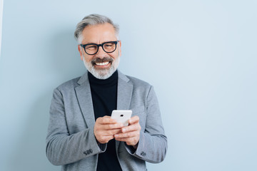 Laughing middle-aged man with smartphone