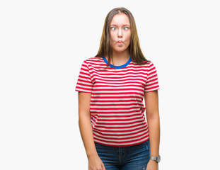 Obraz premium Young caucasian beautiful woman over isolated background making fish face with lips, crazy and comical gesture. Funny expression.