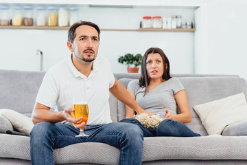 Husband and woman sitting on the couch